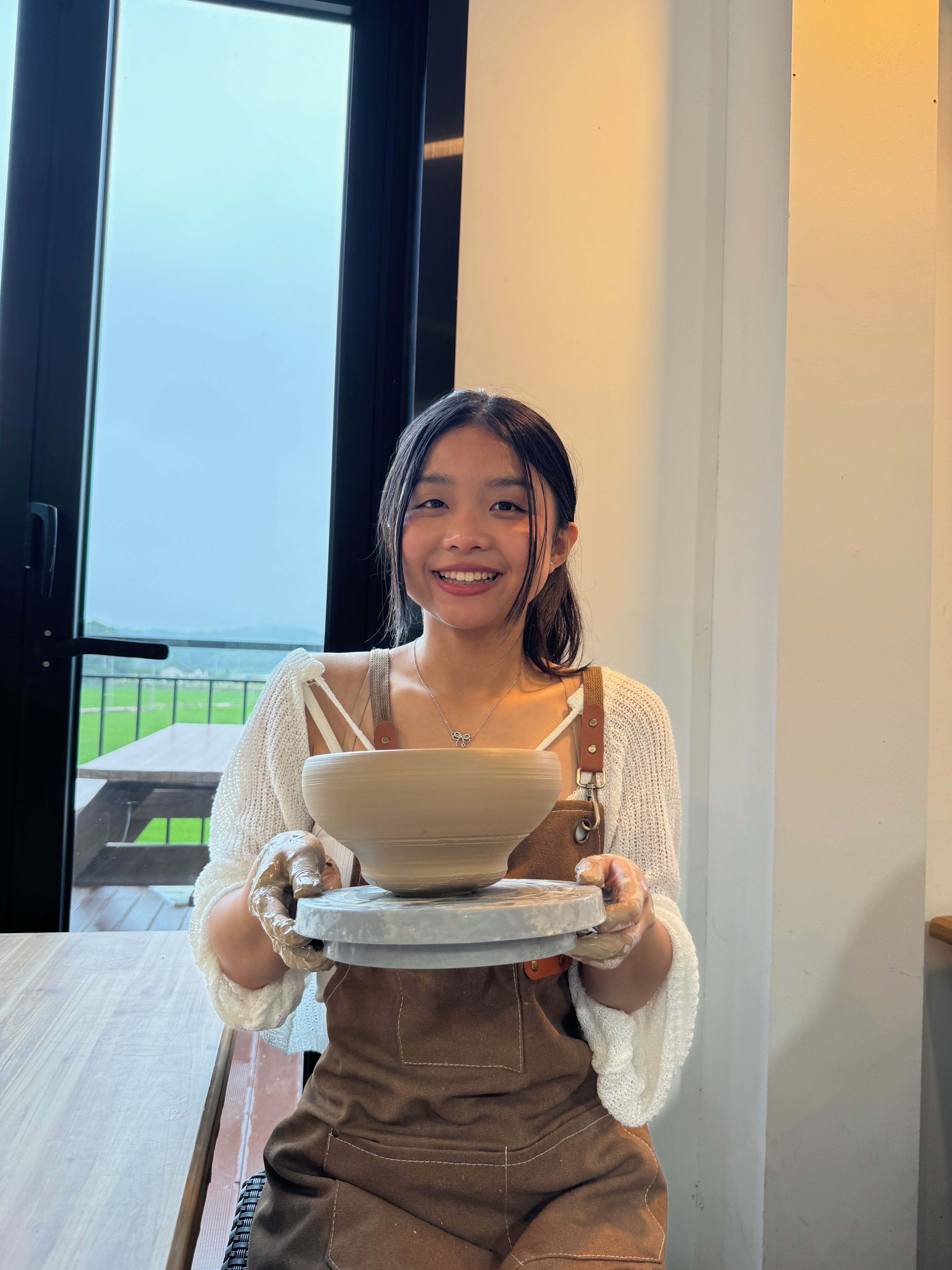 Emily holding a ceramic bowl
