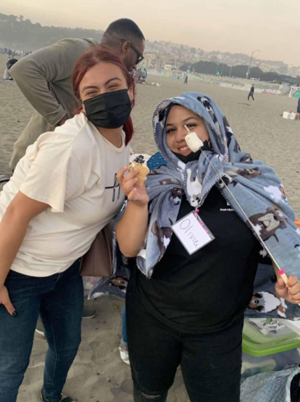 FLY members making s'mores together at the beach